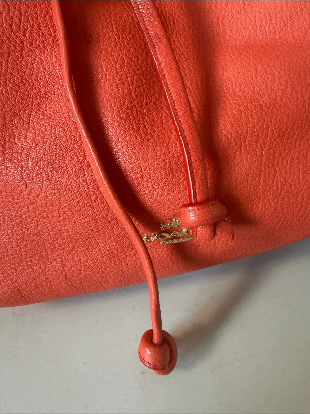Coach Turnlock Tie Bucket Bag – Coral Pebbled Leather Drawstring Shoulder Bag
